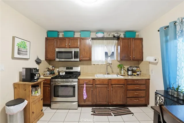 a kitchen with a stove a sink and a microwave