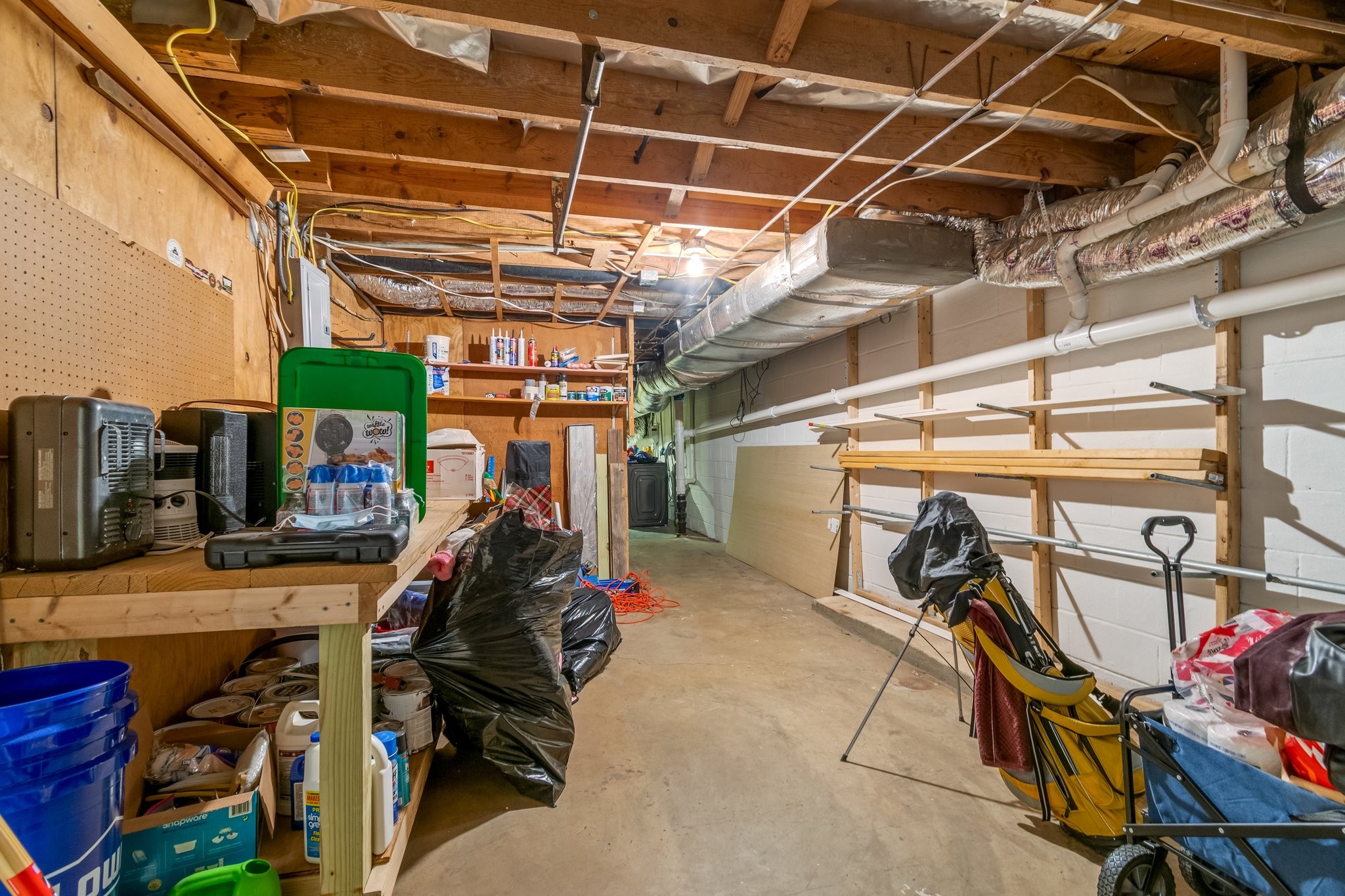 5121 Hilson Road Nashville, TN 37211 - Photo 46 of 63 View to the left inside the unfinished area, showing the workshop area and walkway to the washer/dryer