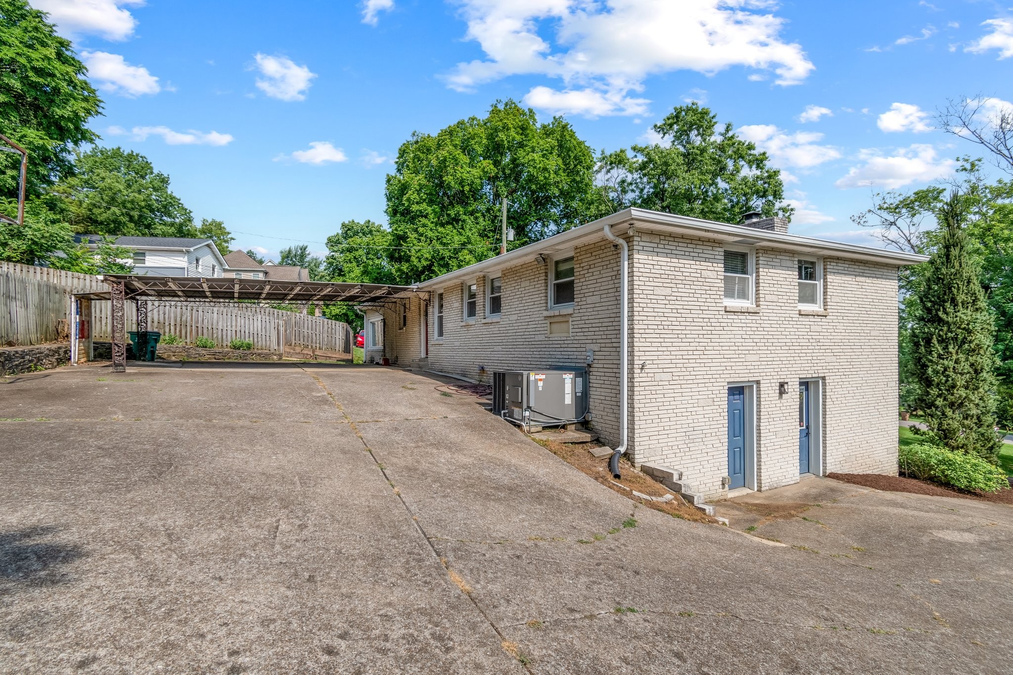 5121 Hilson Road Nashville, TN 37211 - Photo 54 of 63 Large driveway, with the two basement entrances pictured. The door on the right opens to the large possible 4th bed/bonus room/studio, making that area perfect for isolated access