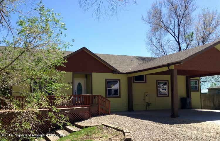 147 East 10th Street Rifle, CO 81650 - Photo 1 of 12 a front view of a house with a yard