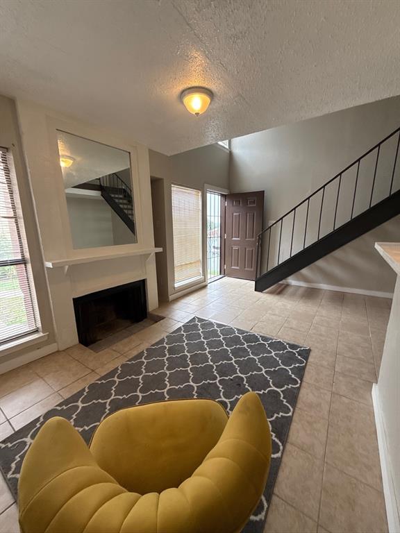 a living room with a rug and a fireplace