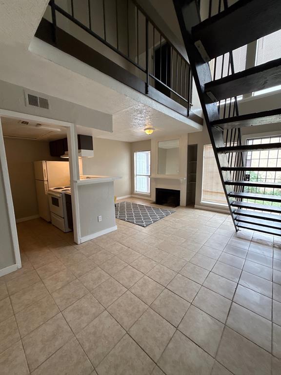 7152 Fair Oaks Avenue, Unit 1181 Dallas, TX 75231 - Photo 2 of 11 a view of a livingroom with a staircase