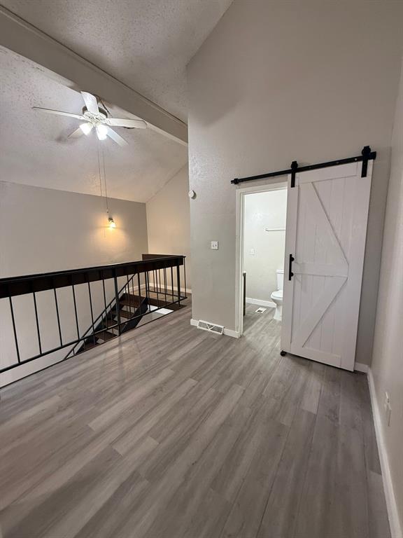 7152 Fair Oaks Avenue, Unit 1181 Dallas, TX 75231 - Photo 5 of 11 wooden floor in an empty room with a window