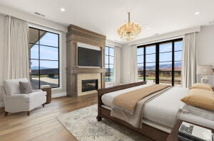 1141 East Lost Ridge Drive Washington, UT 84780 - Photo 59 of 108 Spacious room featuring wood-finish flooring, a built-in fireplace with a stone surround, and large windows