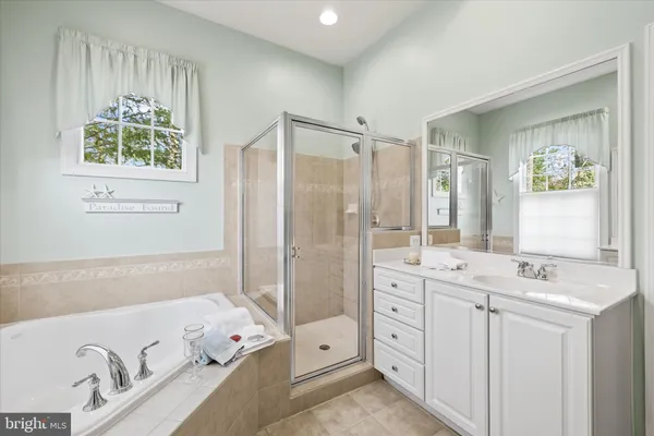 a bathroom with a sink vanity and a mirror