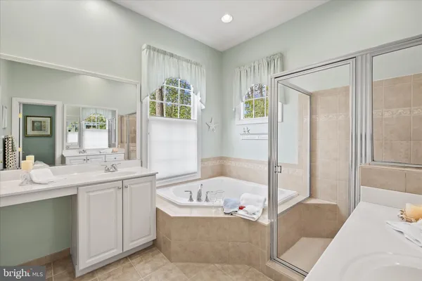 a bathroom with a sink a mirror and a window