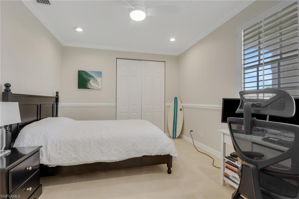 1859 Ivory Cane Point Naples, FL 34119 - Photo 22 of 50 Bedroom featuring light colored carpet, a closet, crown molding, recessed lighting, and a desk