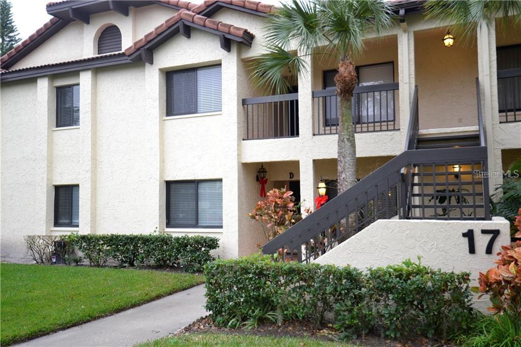 1801 East Lake Road South, Unit 17I Palm Harbor, FL 34685 - Photo 1 of 1 a view of a house with brick walls and a yard with plants