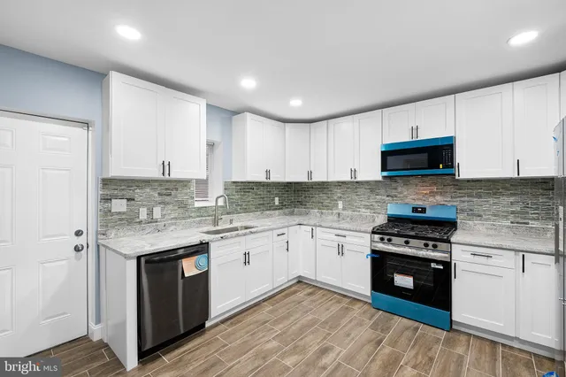 a kitchen with granite countertop wooden cabinets and a stove top oven