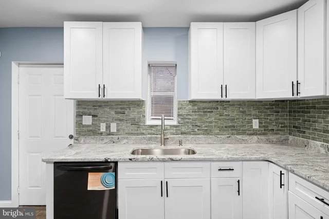 a kitchen with stainless steel appliances granite countertop a sink and cabinets