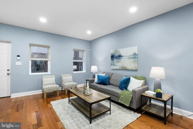 a living room with furniture and wooden floor