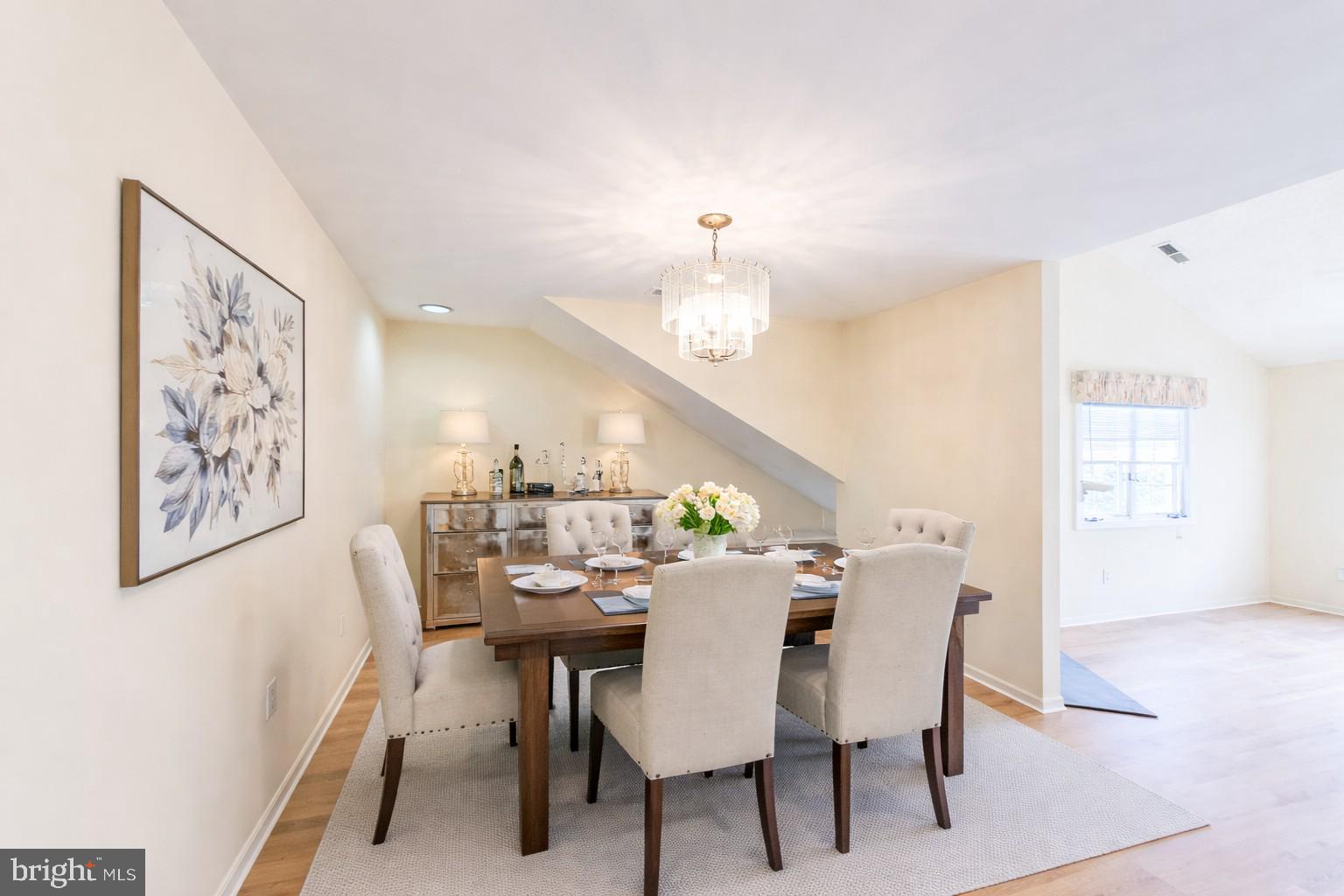 1 Rutland Lane Monroe Township, NJ 08831 - Photo 15 of 26 a view of a dining room with furniture and a chandelier