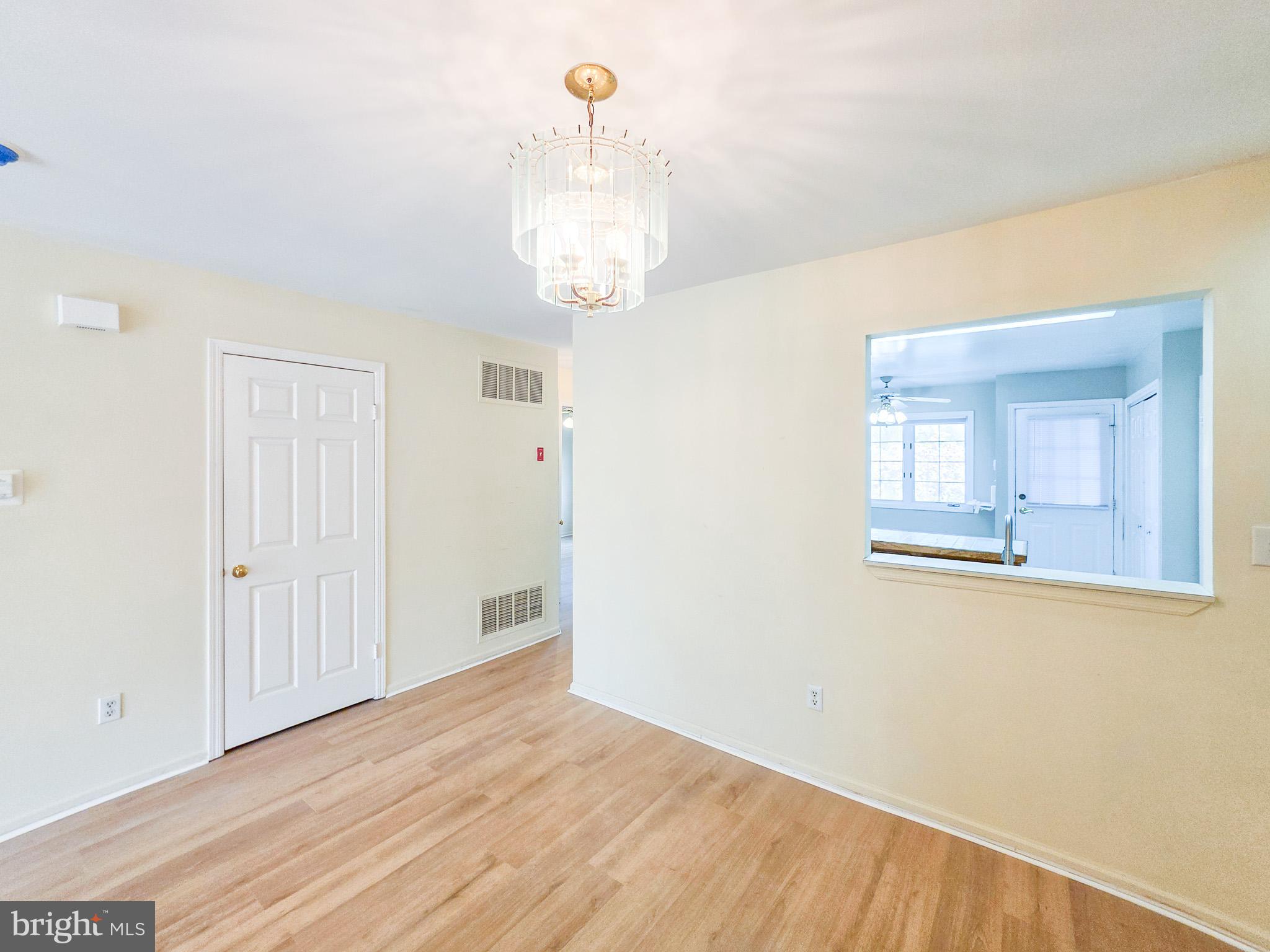1 Rutland Lane Monroe Township, NJ 08831 - Photo 17 of 26 a view of a room with wooden floor and chandelier