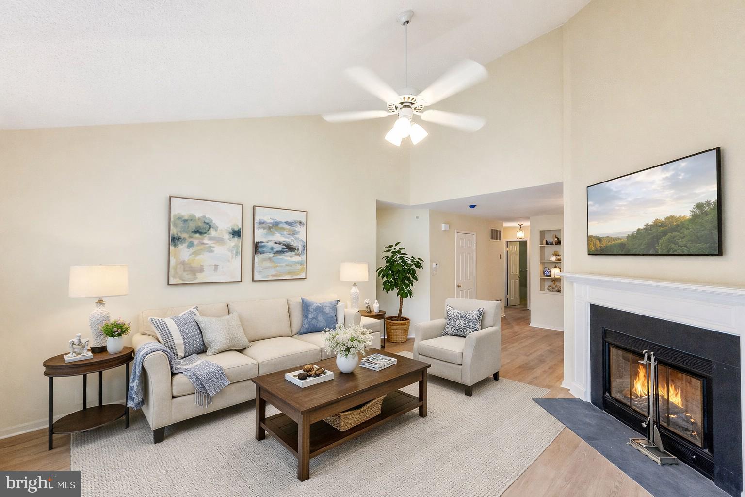 1 Rutland Lane Monroe Township, NJ 08831 - Photo 21 of 26 a living room with furniture a flat screen tv and a fireplace