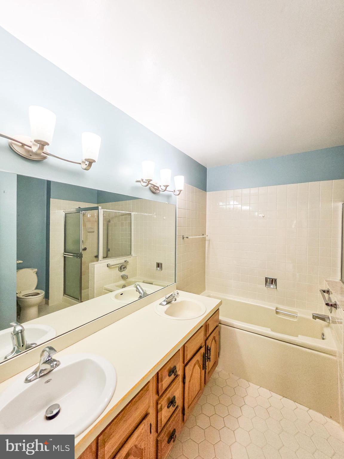 1 Rutland Lane Monroe Township, NJ 08831 - Photo 25 of 26 a spacious bathroom with a double vanity sink mirror and bathtub