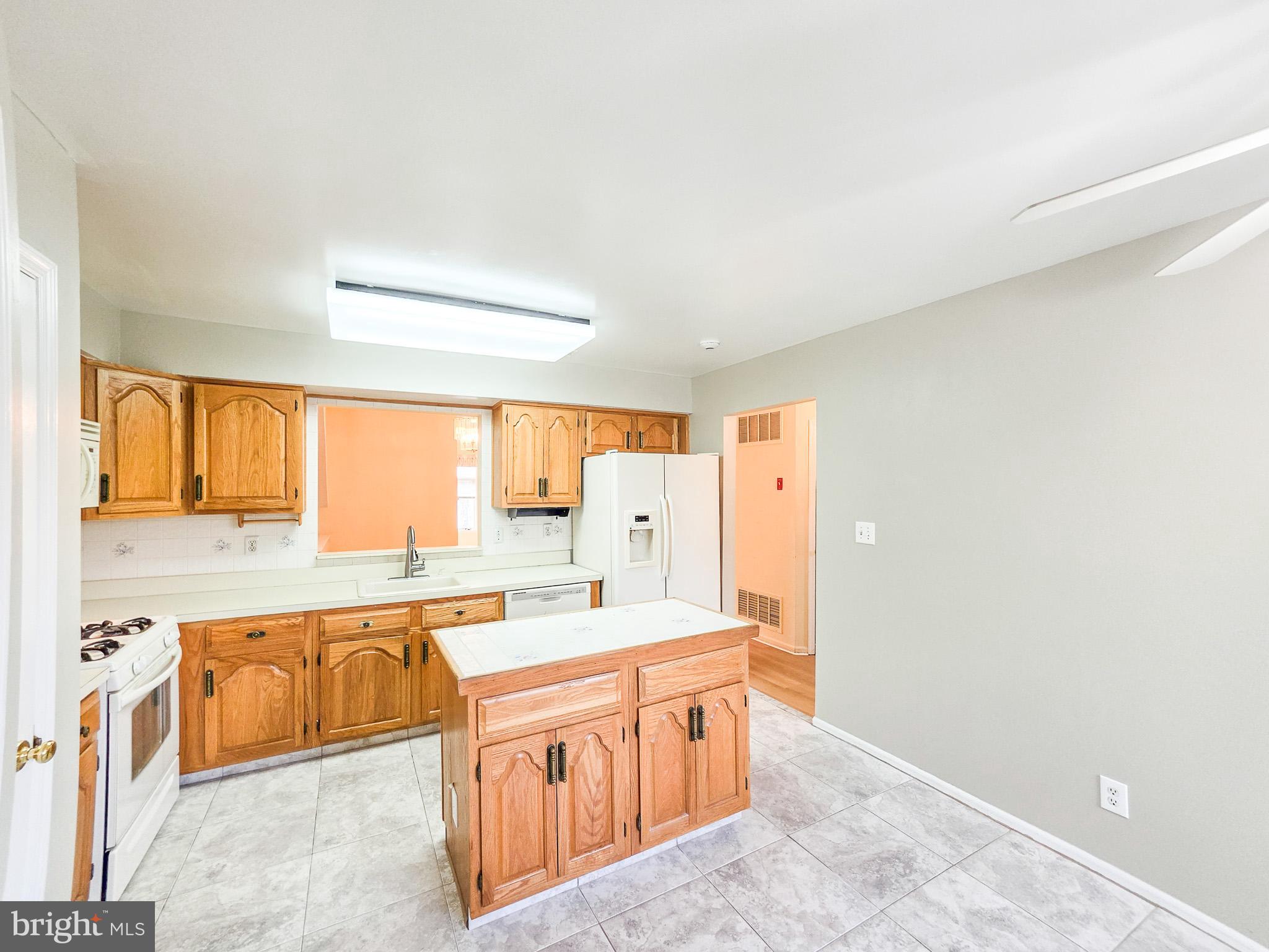 1 Rutland Lane Monroe Township, NJ 08831 - Photo 5 of 26 a large kitchen with stainless steel appliances a sink and cabinets
