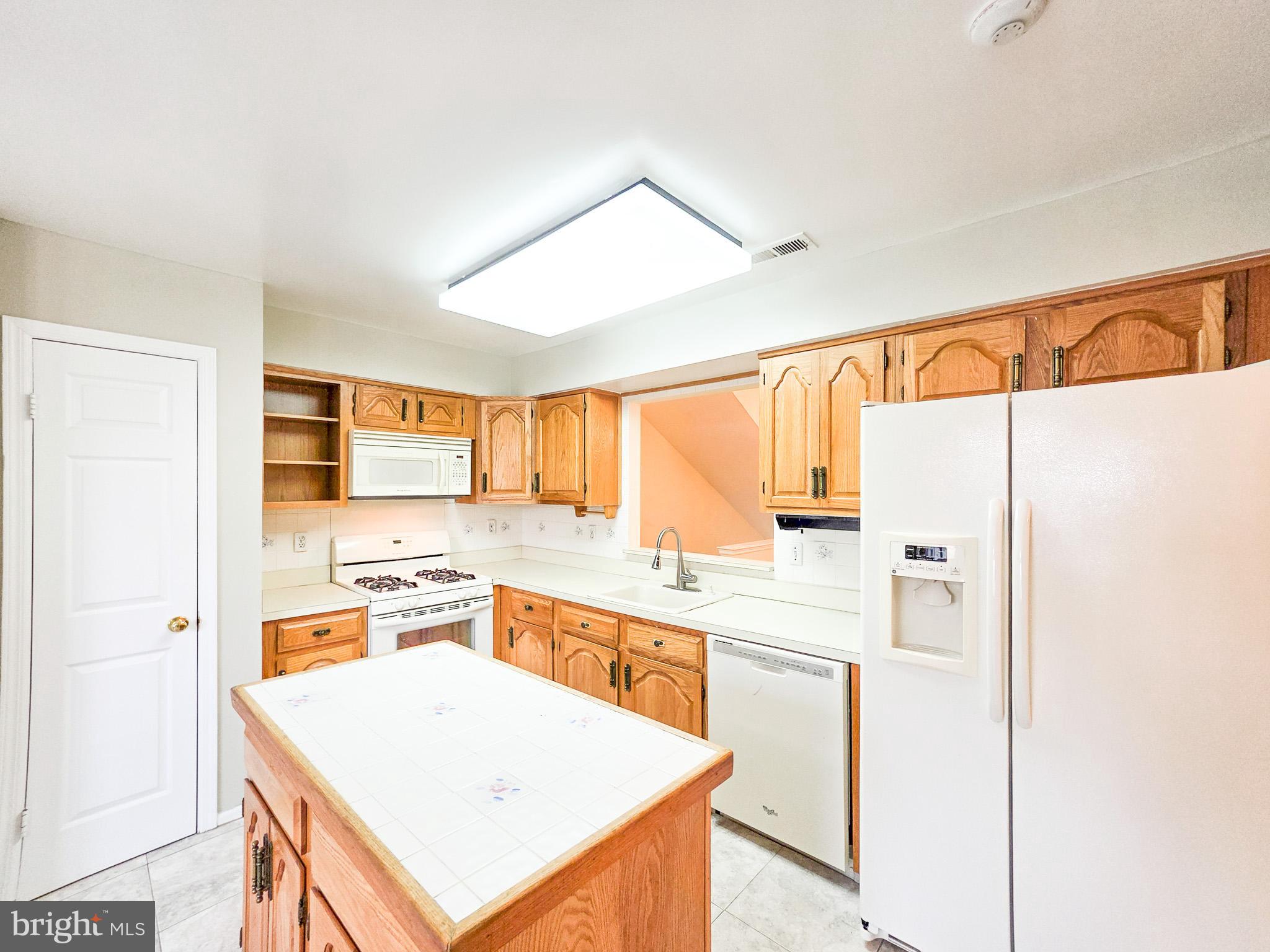 1 Rutland Lane Monroe Township, NJ 08831 - Photo 7 of 26 a kitchen with stainless steel appliances a refrigerator a sink and white cabinets