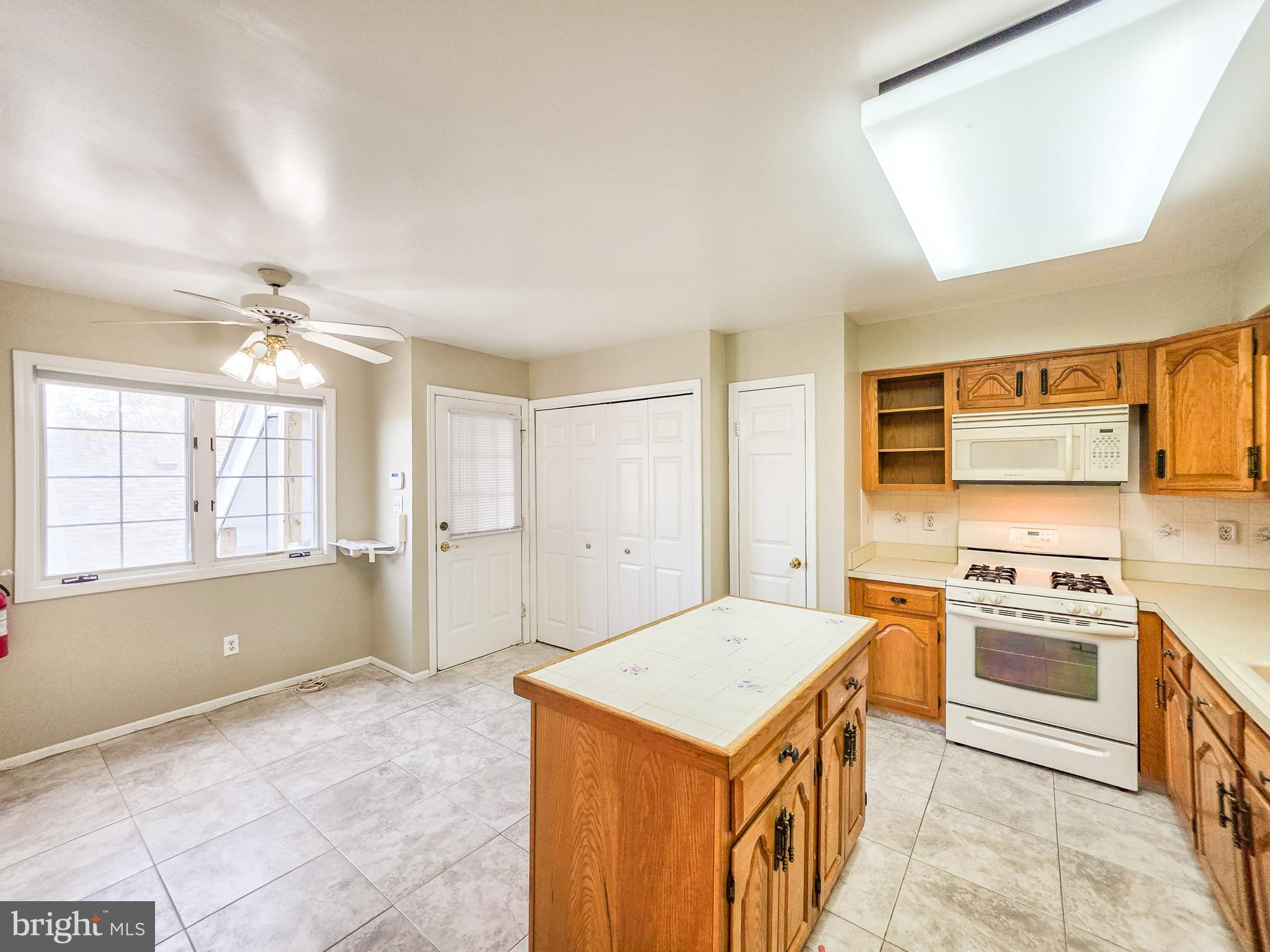 1 Rutland Lane Monroe Township, NJ 08831 - Photo 8 of 26 a kitchen with a stove a sink and a refrigerator
