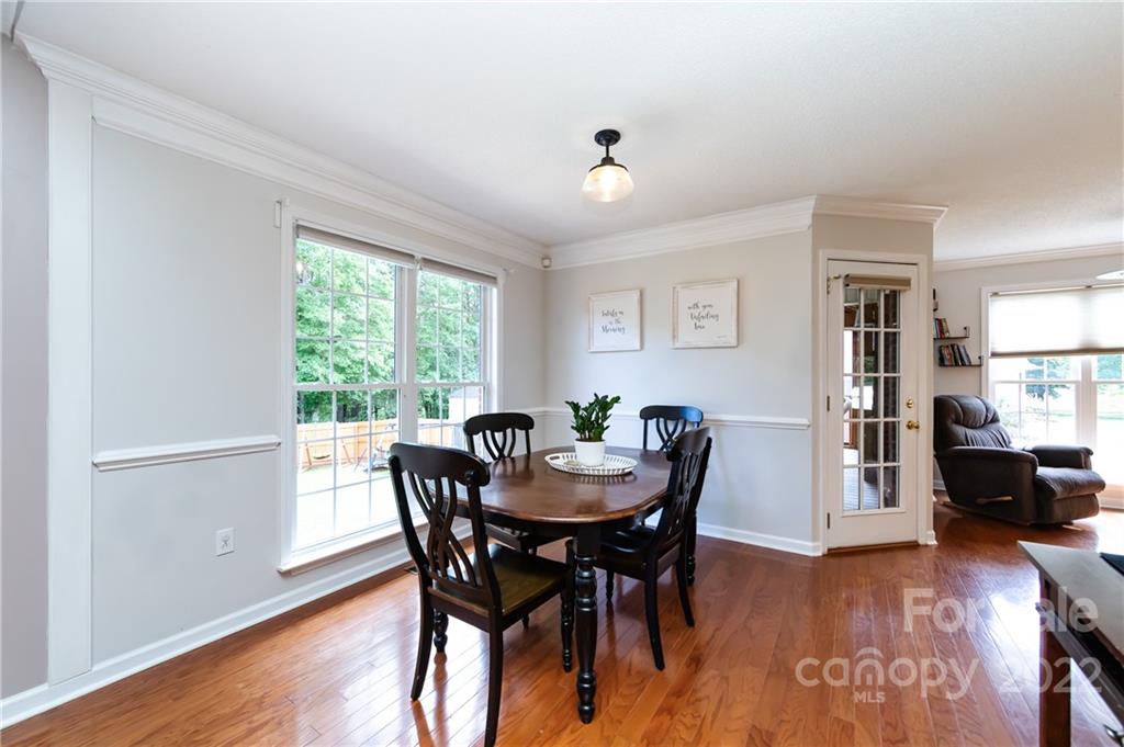 7760 Wallace Lane Denver, NC 28037 - Photo 11 of 48 a view of a dining room with furniture window and wooden floor