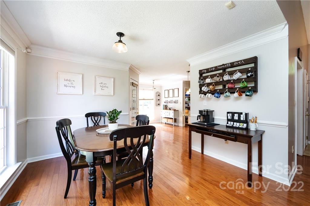 7760 Wallace Lane Denver, NC 28037 - Photo 12 of 48 a view of a dining room with furniture window and wooden floor