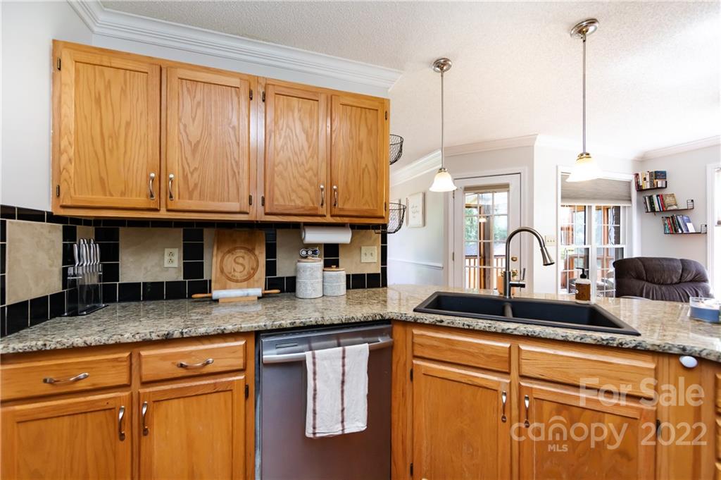 7760 Wallace Lane Denver, NC 28037 - Photo 14 of 48 a kitchen with granite countertop a sink a stove and cabinets