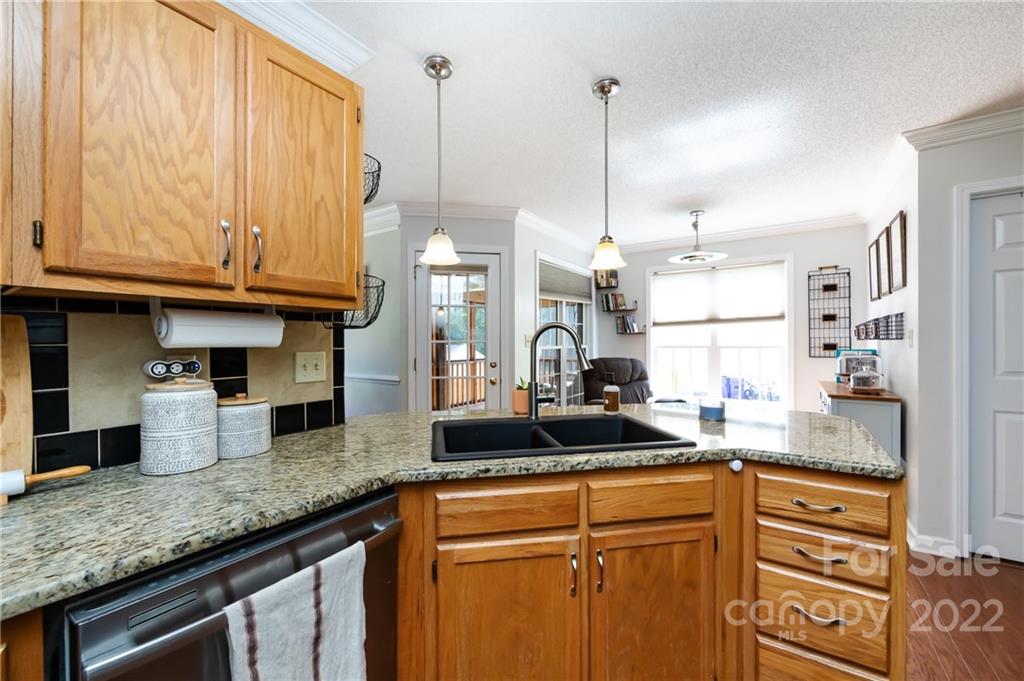 7760 Wallace Lane Denver, NC 28037 - Photo 15 of 48 a kitchen with stainless steel appliances granite countertop a sink a stove and a wooden cabinets