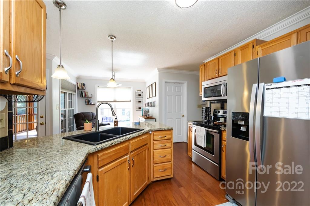 7760 Wallace Lane Denver, NC 28037 - Photo 16 of 48 a kitchen with stainless steel appliances granite countertop a refrigerator a stove and a sink