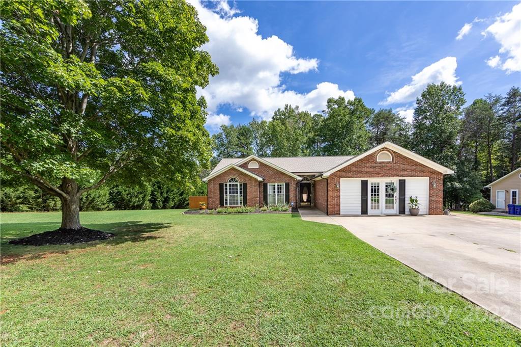 7760 Wallace Lane Denver, NC 28037 - Photo 2 of 48 a front view of a house with a yard and trees