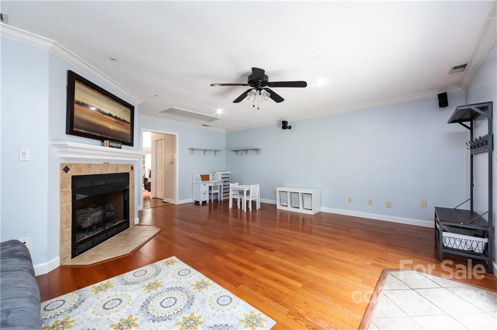 7760 Wallace Lane Denver, NC 28037 - Photo 26 of 48 a living room with furniture a flat screen tv and a fireplace