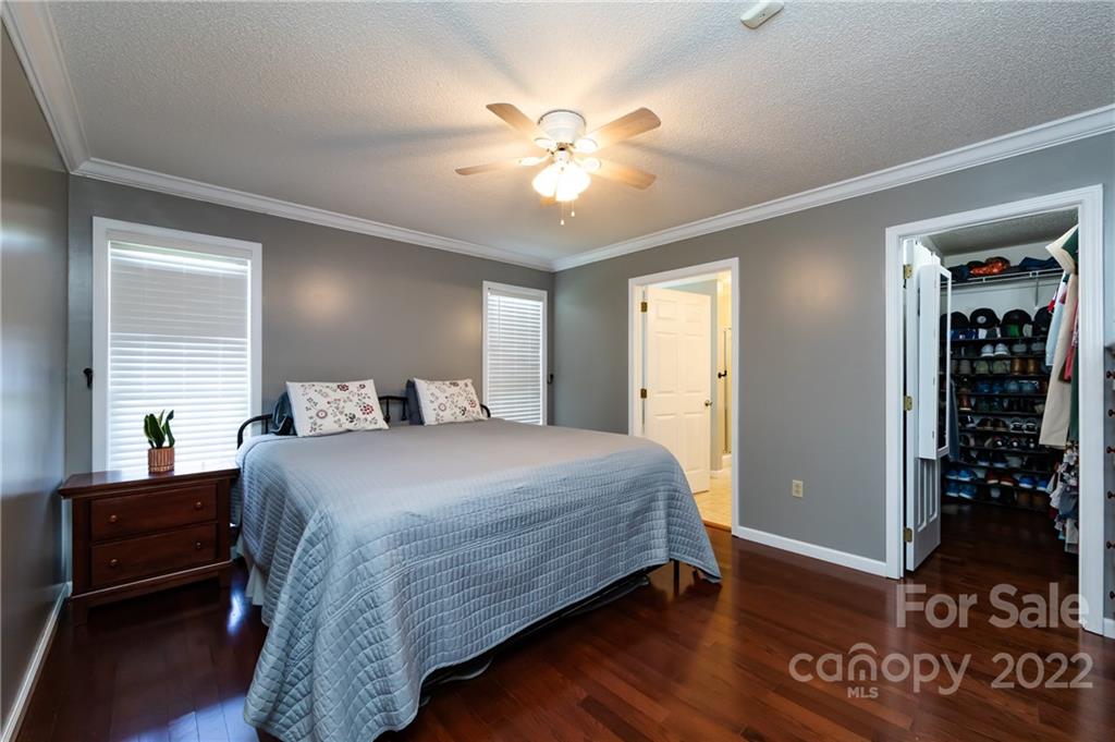 7760 Wallace Lane Denver, NC 28037 - Photo 30 of 48 a bedroom with a bed and wooden floor