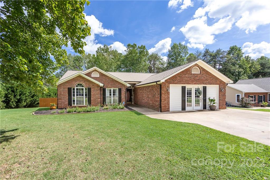 7760 Wallace Lane Denver, NC 28037 - Photo 3 of 48 a front view of a house with a yard and garage