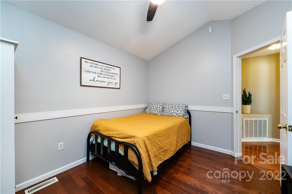 7760 Wallace Lane Denver, NC 28037 - Photo 36 of 48 a bedroom with a bed and wooden floor
