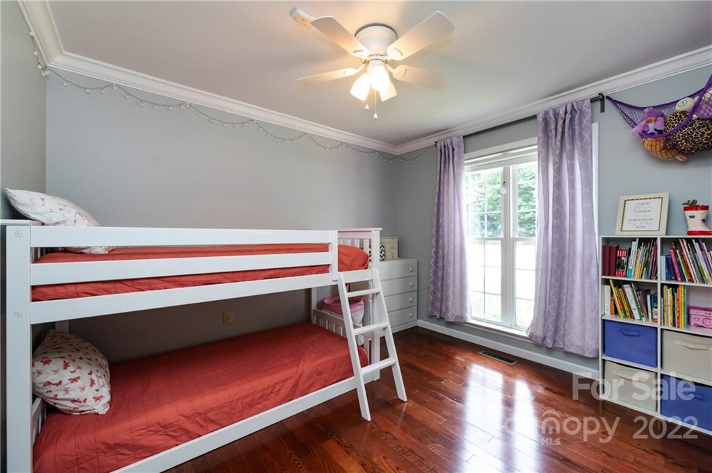 7760 Wallace Lane Denver, NC 28037 - Photo 40 of 48 a bedroom with bunk bed and a book shelf
