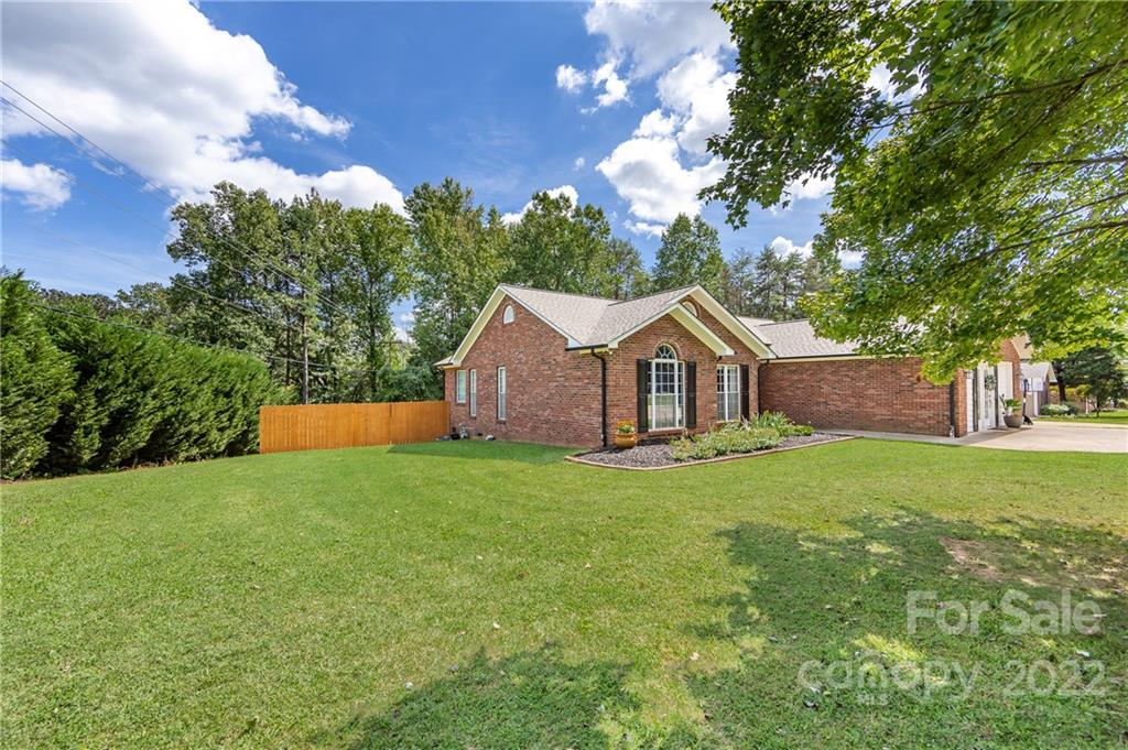 7760 Wallace Lane Denver, NC 28037 - Photo 4 of 48 a front view of a house with garden