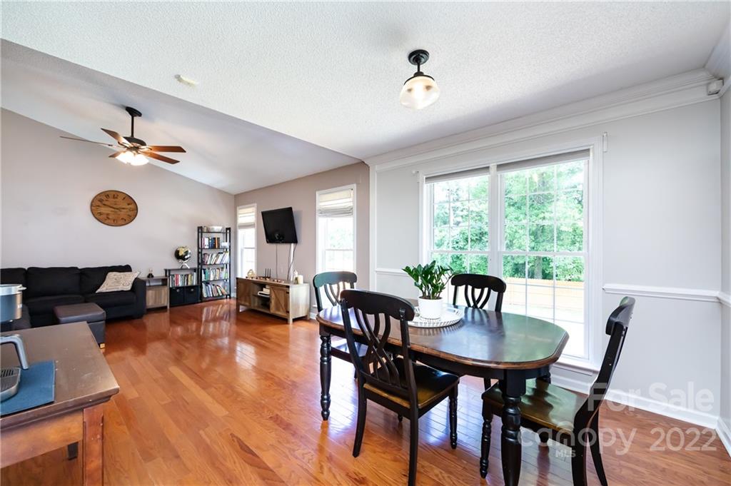 7760 Wallace Lane Denver, NC 28037 - Photo 10 of 48 a view of a dining room with furniture and wooden floor