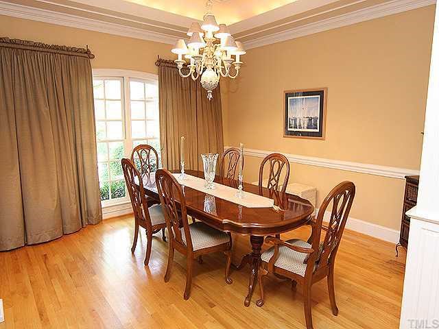 4000 John S Raboteau Wynd Raleigh, NC 27612 - Photo 3 of 12 a view of a dining room with furniture and chandelier