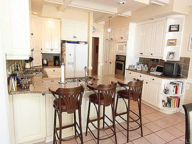 4000 John S Raboteau Wynd Raleigh, NC 27612 - Photo 6 of 12 a view of a dining hall with stainless steel appliances kitchen island granite countertop a table and chairs