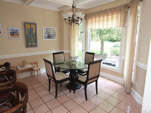 4000 John S Raboteau Wynd Raleigh, NC 27612 - Photo 7 of 12 a dining room with furniture a chandelier and window