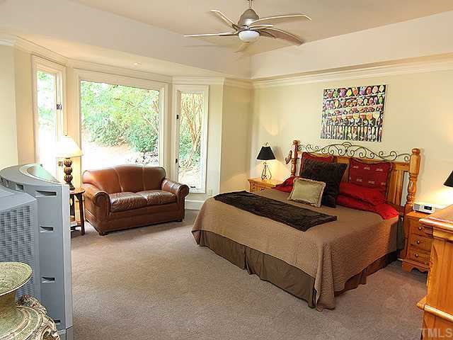 4000 John S Raboteau Wynd Raleigh, NC 27612 - Photo 8 of 12 a bedroom with a bed and a couch