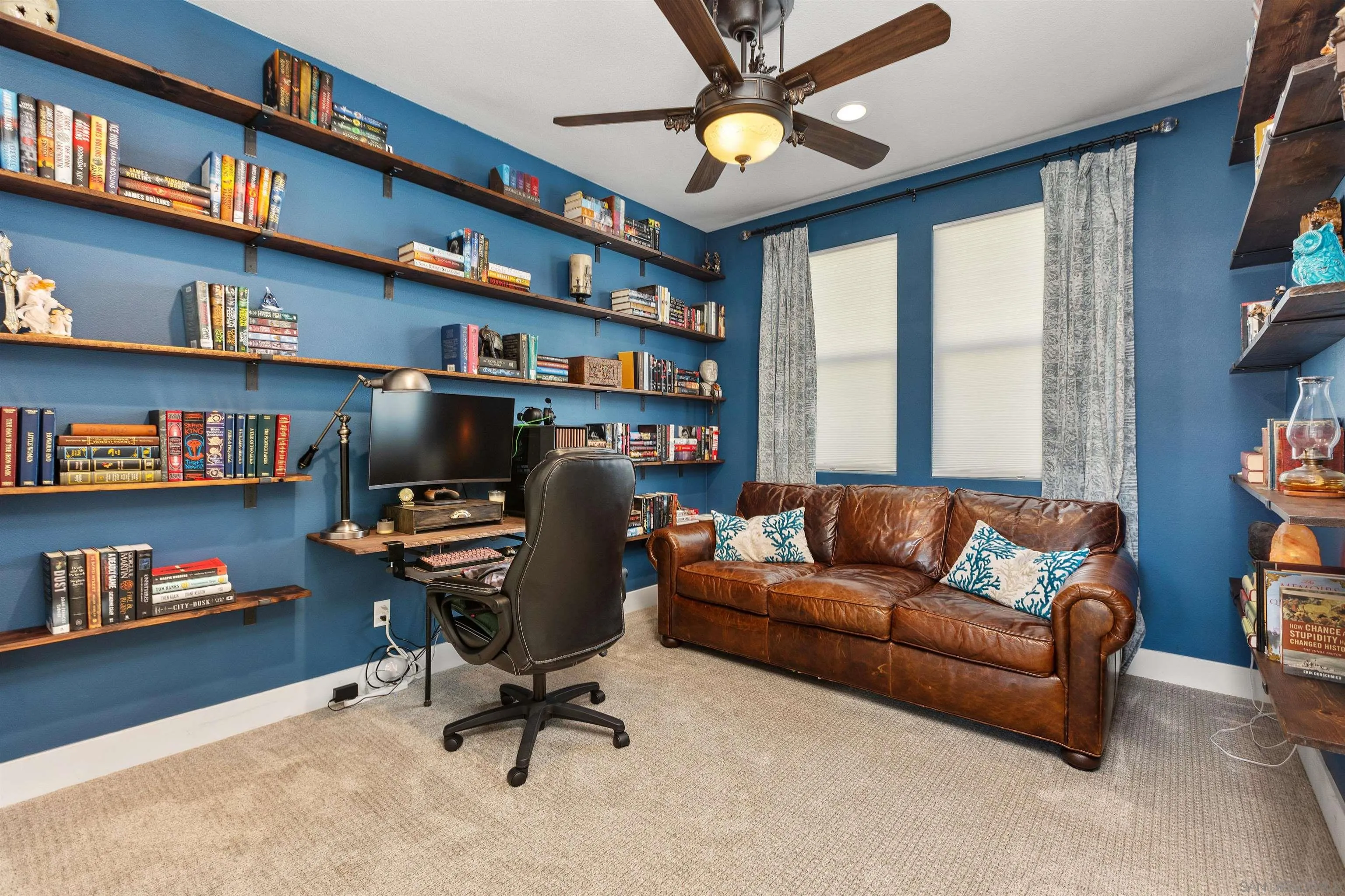 238 Ventasso Way Fallbrook, CA 92028 - Photo 23 of 52 a view of a livingroom with workspace and a bookshelf