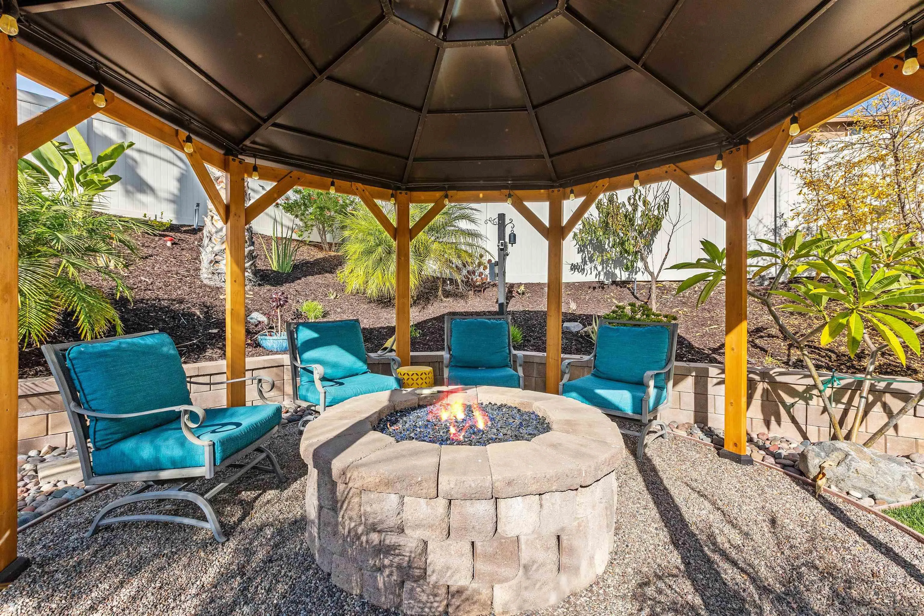 238 Ventasso Way Fallbrook, CA 92028 - Photo 36 of 52 a view of a patio with a table chairs and a backyard