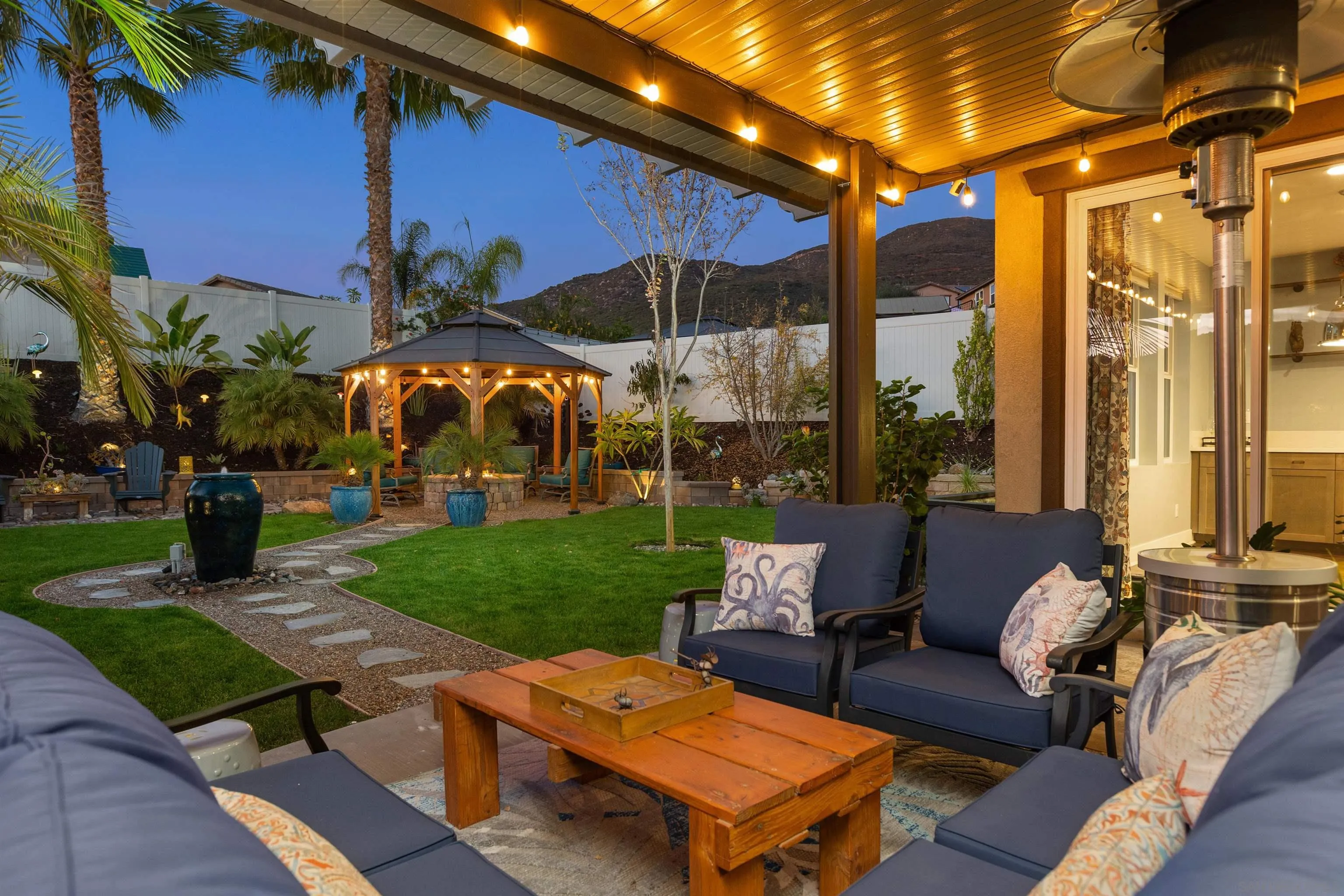 238 Ventasso Way Fallbrook, CA 92028 - Photo 41 of 52 a view of a patio with couches and table and chairs with plants and trees