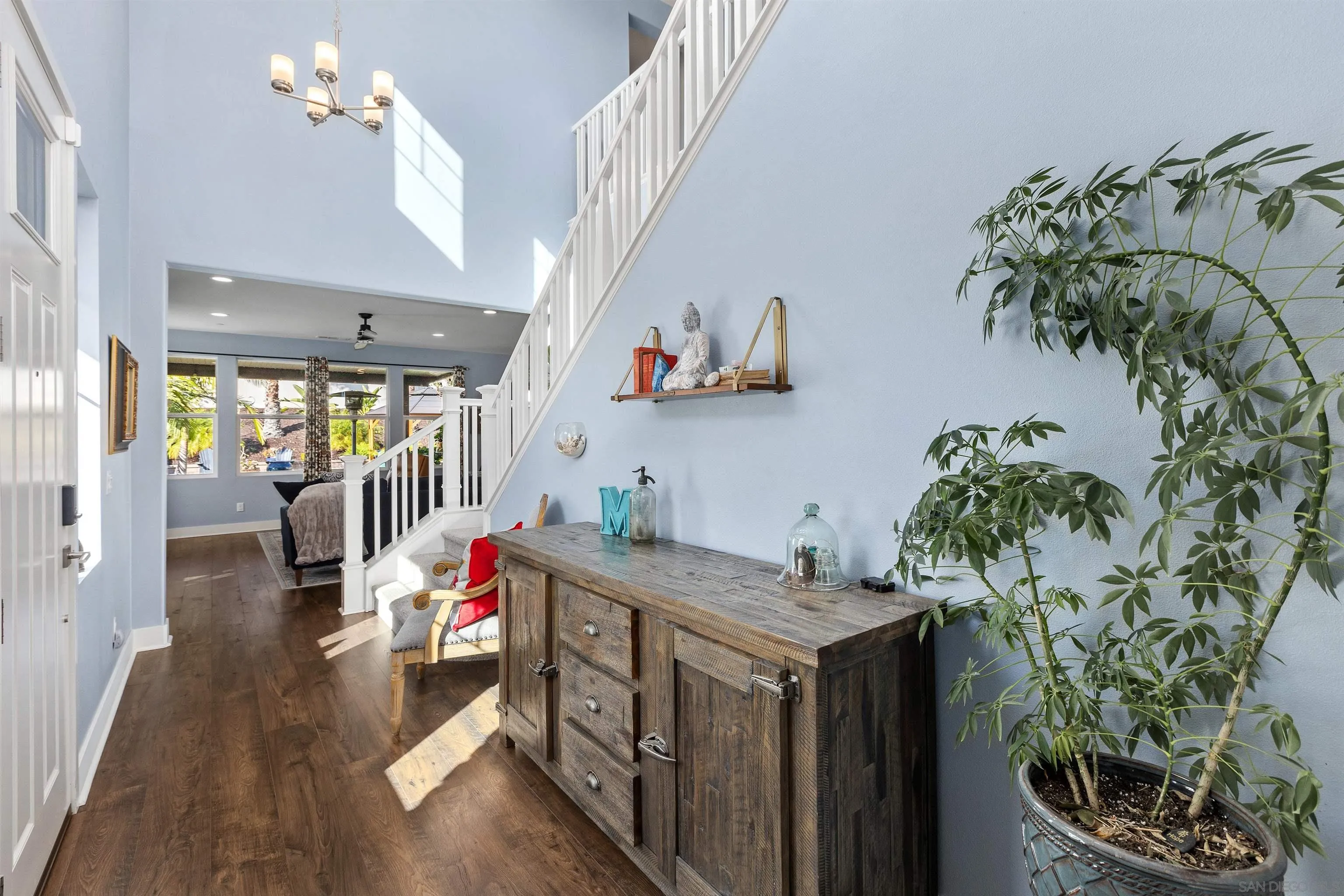 238 Ventasso Way Fallbrook, CA 92028 - Photo 7 of 52 a hallway with a lots of white furniture and a wooden floor