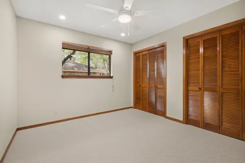 an empty room with windows and closet