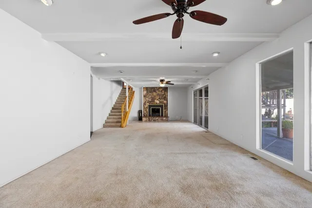 a view of a livingroom with a ceiling fan and window
