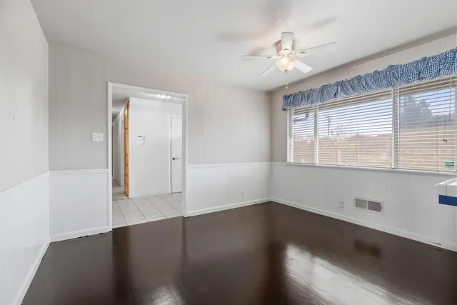 a kitchen with a sink cabinets and wooden floor