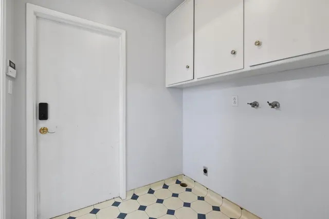 a view of a hallway with wooden floor and closet