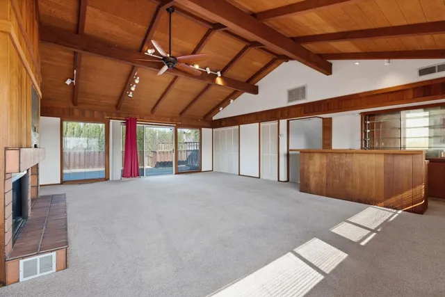 a view of deck with wooden floor and fence with a bench