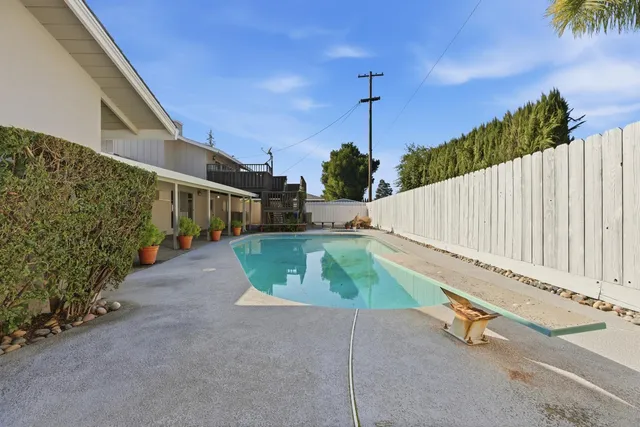 a view of a porch with furniture and garden