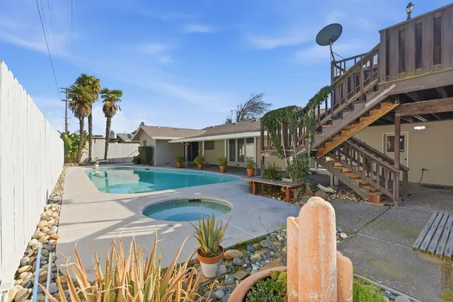 a view of a porch with furniture and garden